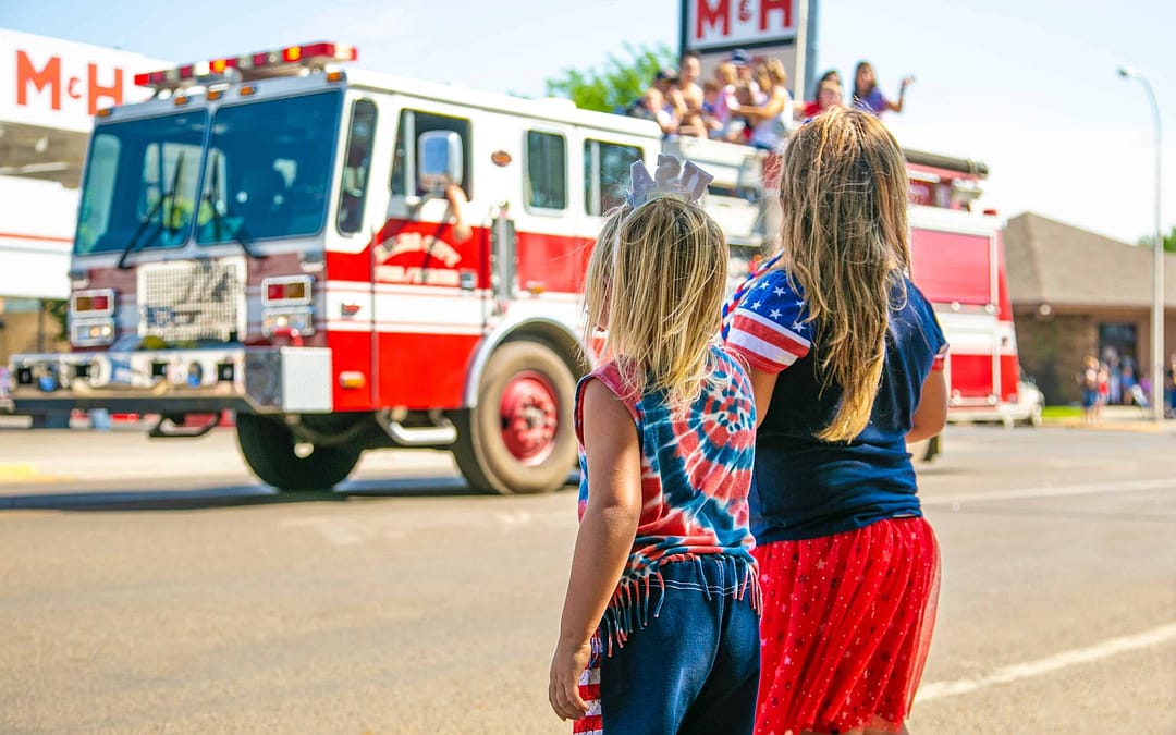 two girls looking at a firetruck