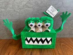 A tissue box painted green to look like a monster